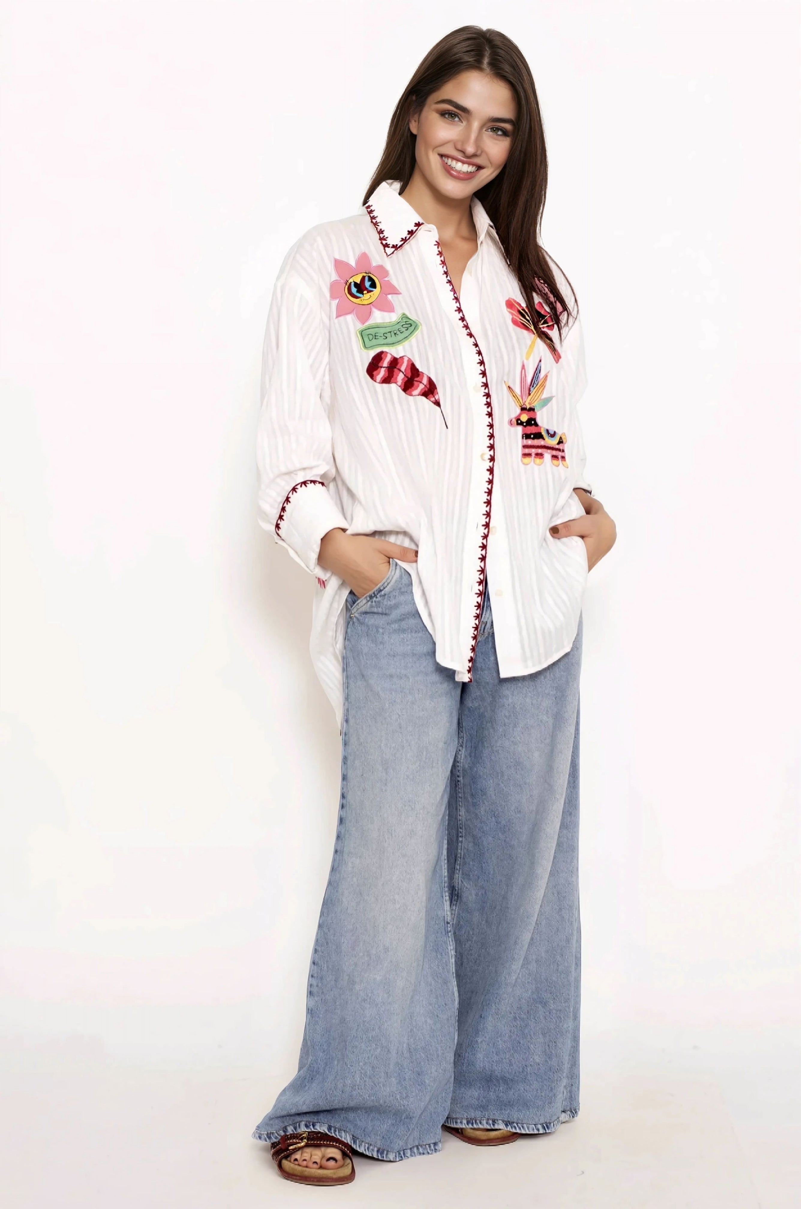 Smiling Brown hair girl with a white cotton shirt with colorful handmade embroideries