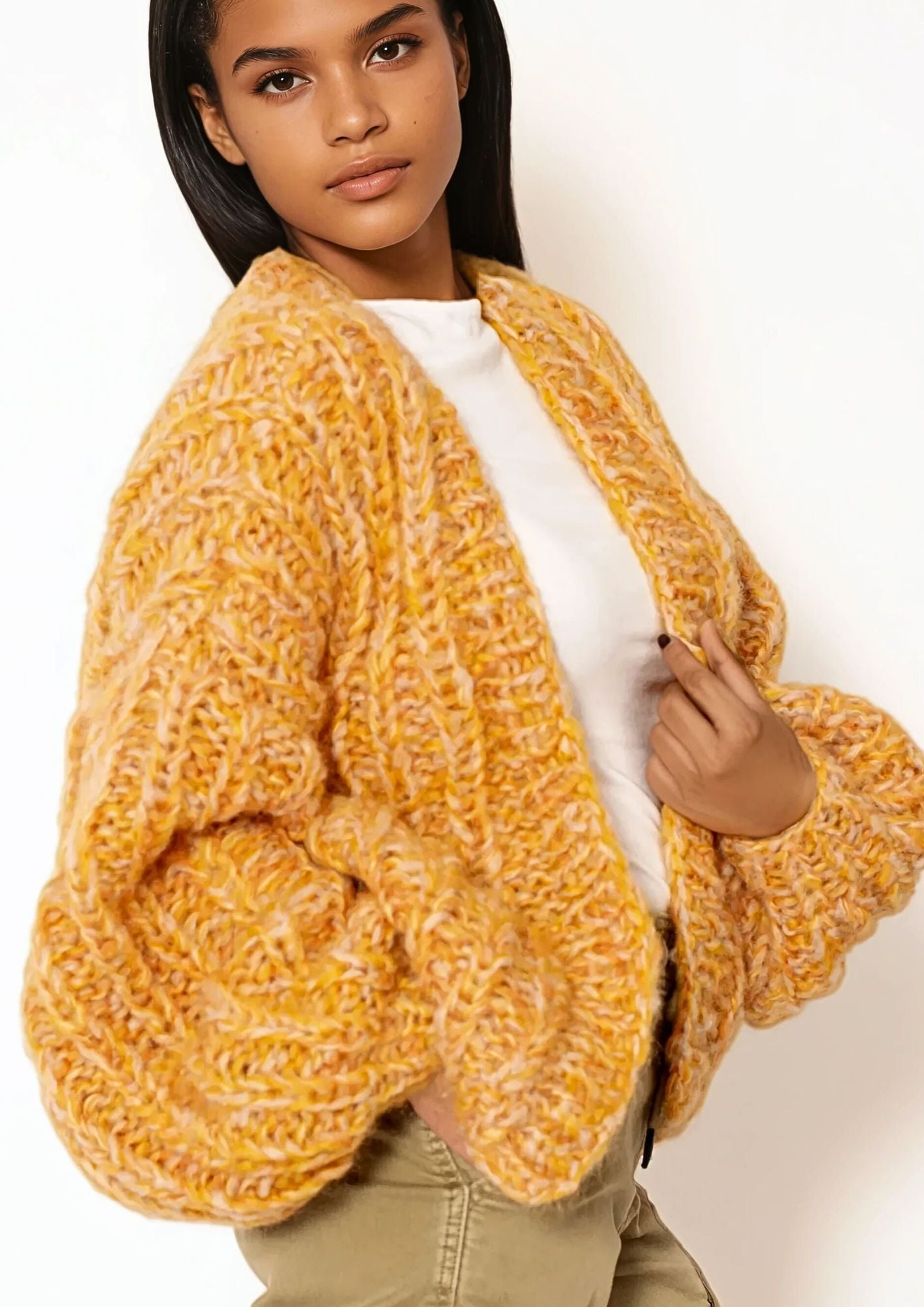 Girl with dark hair in white t shirt and light orange  handknitted oversized luxury mohair cardigan