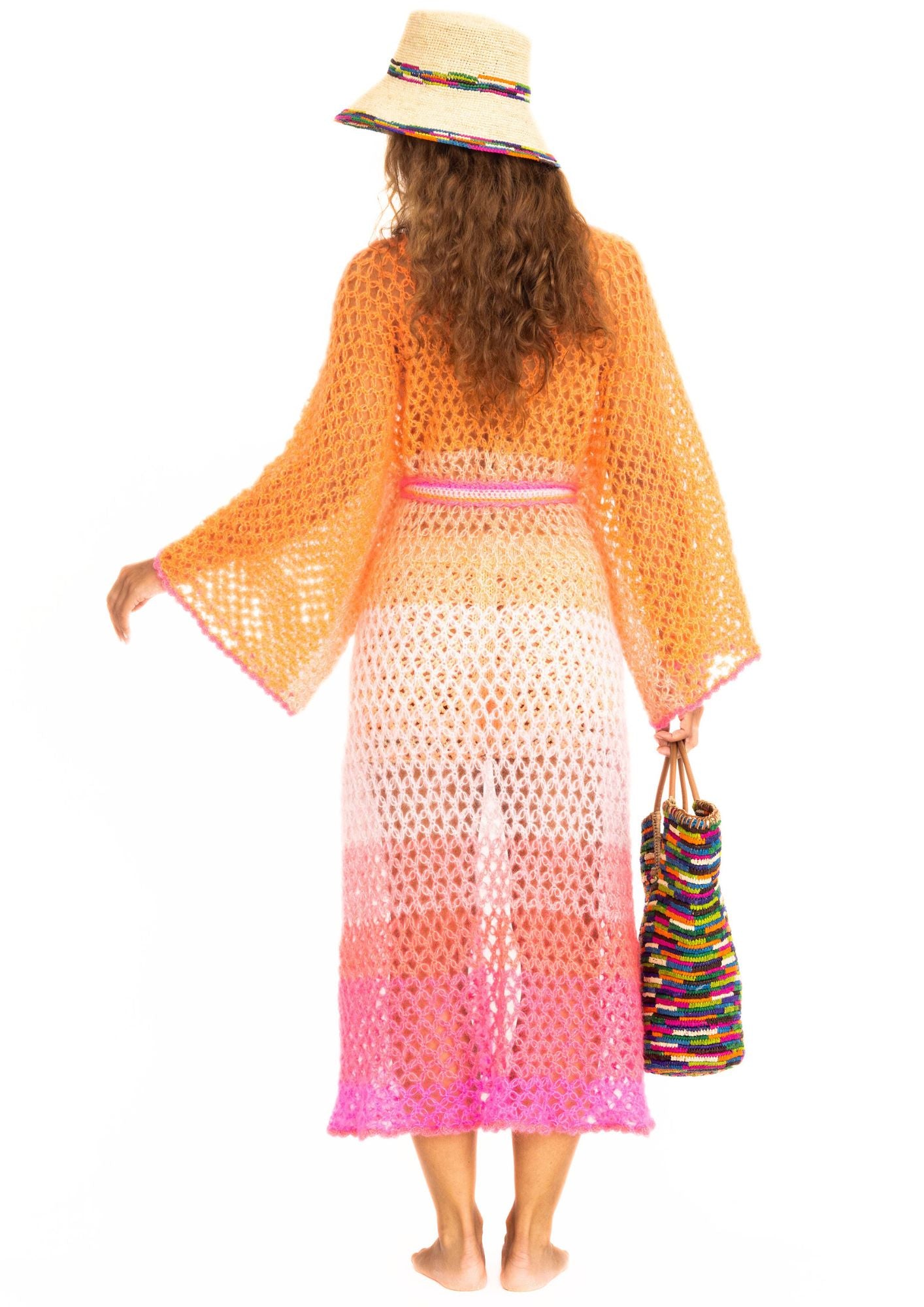 a handcrochet silk kimono in silk and kid mohair in ombre shades from pink to orange from the back plus a crochet beachbag
