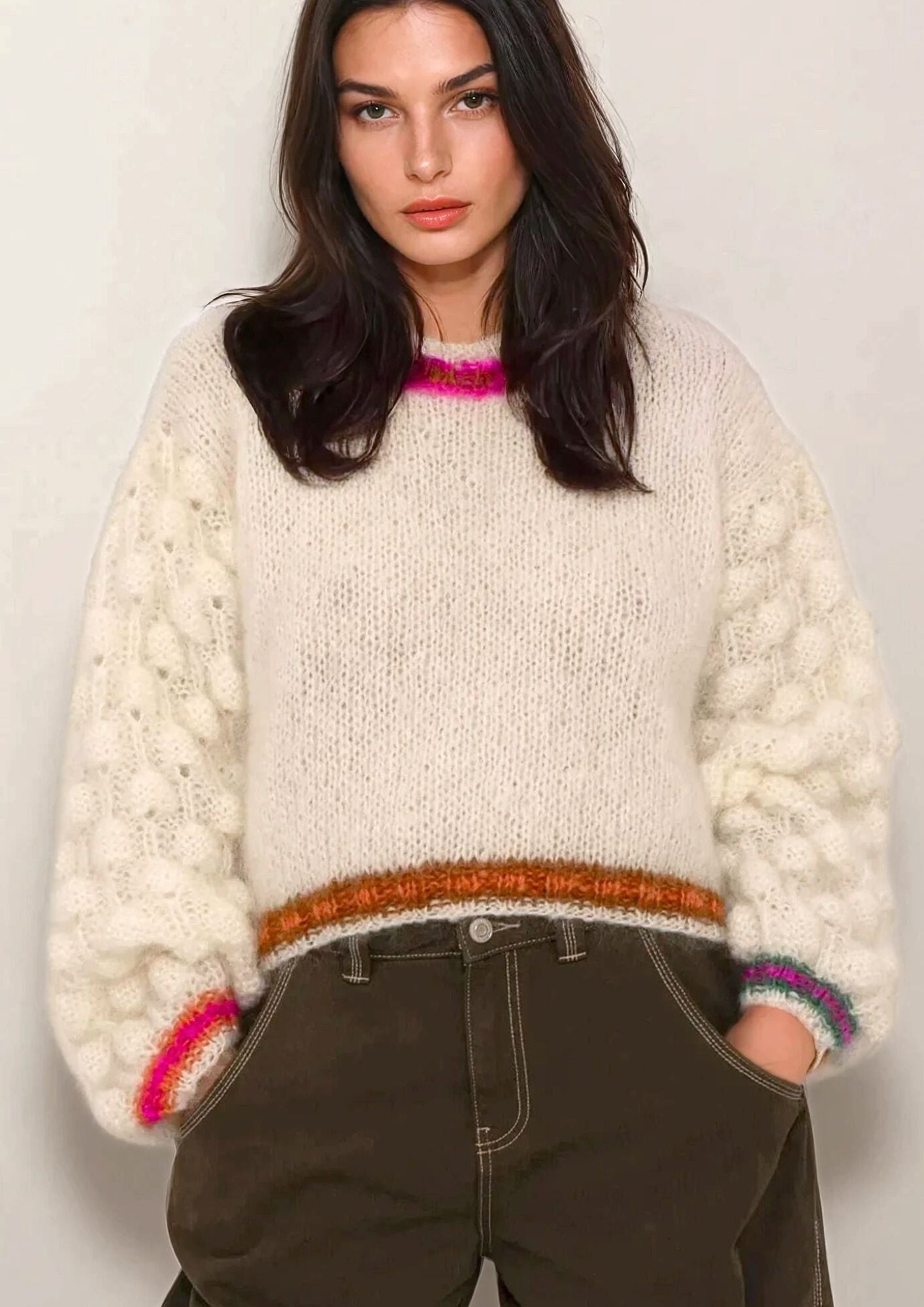 Girl in handknitted white mohair sweater with colored cuffs and borders