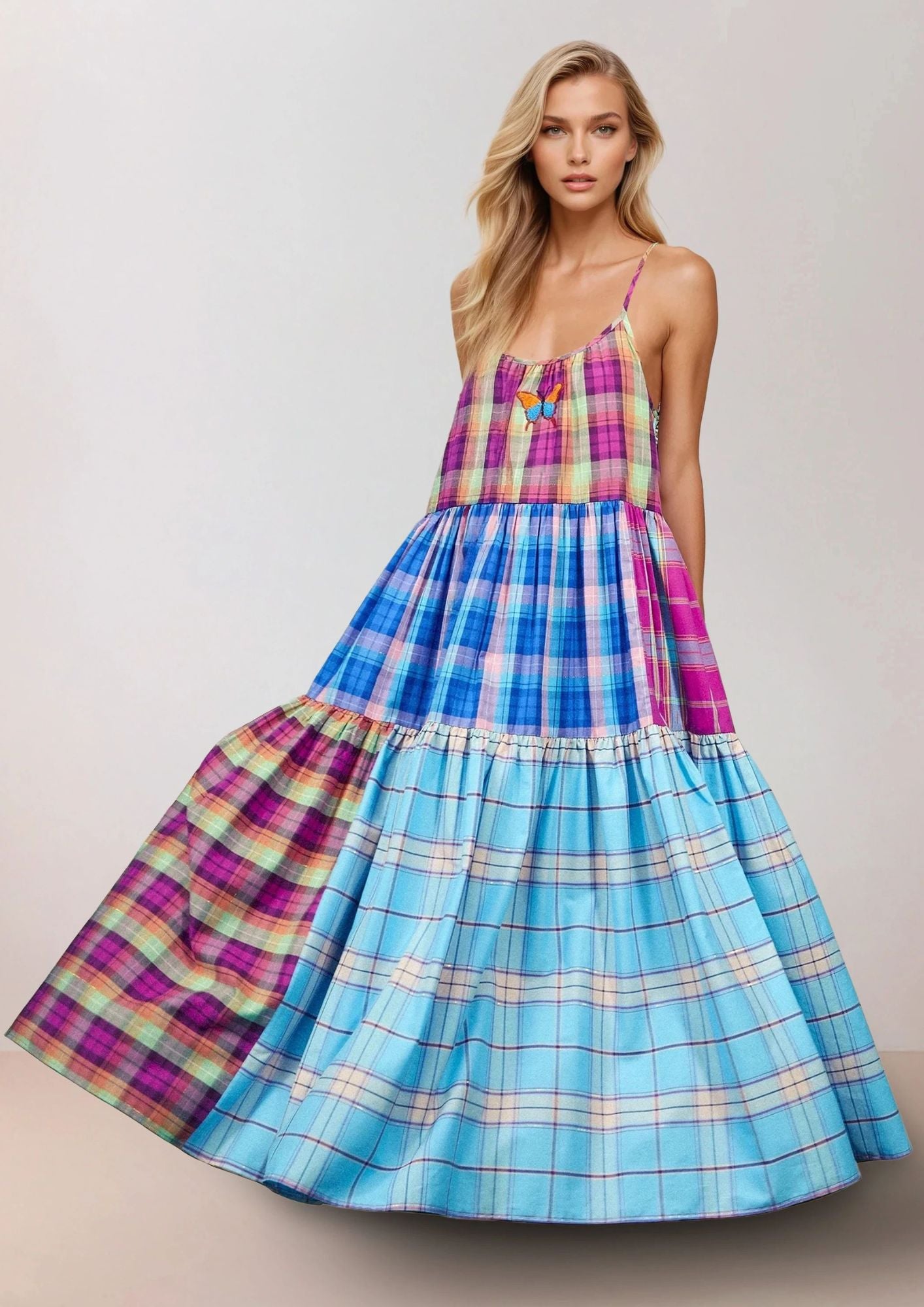 Beautiful Blonde girl wearing a Susanna Blu dress wih Gingham colorfabric and butterfly embroidery