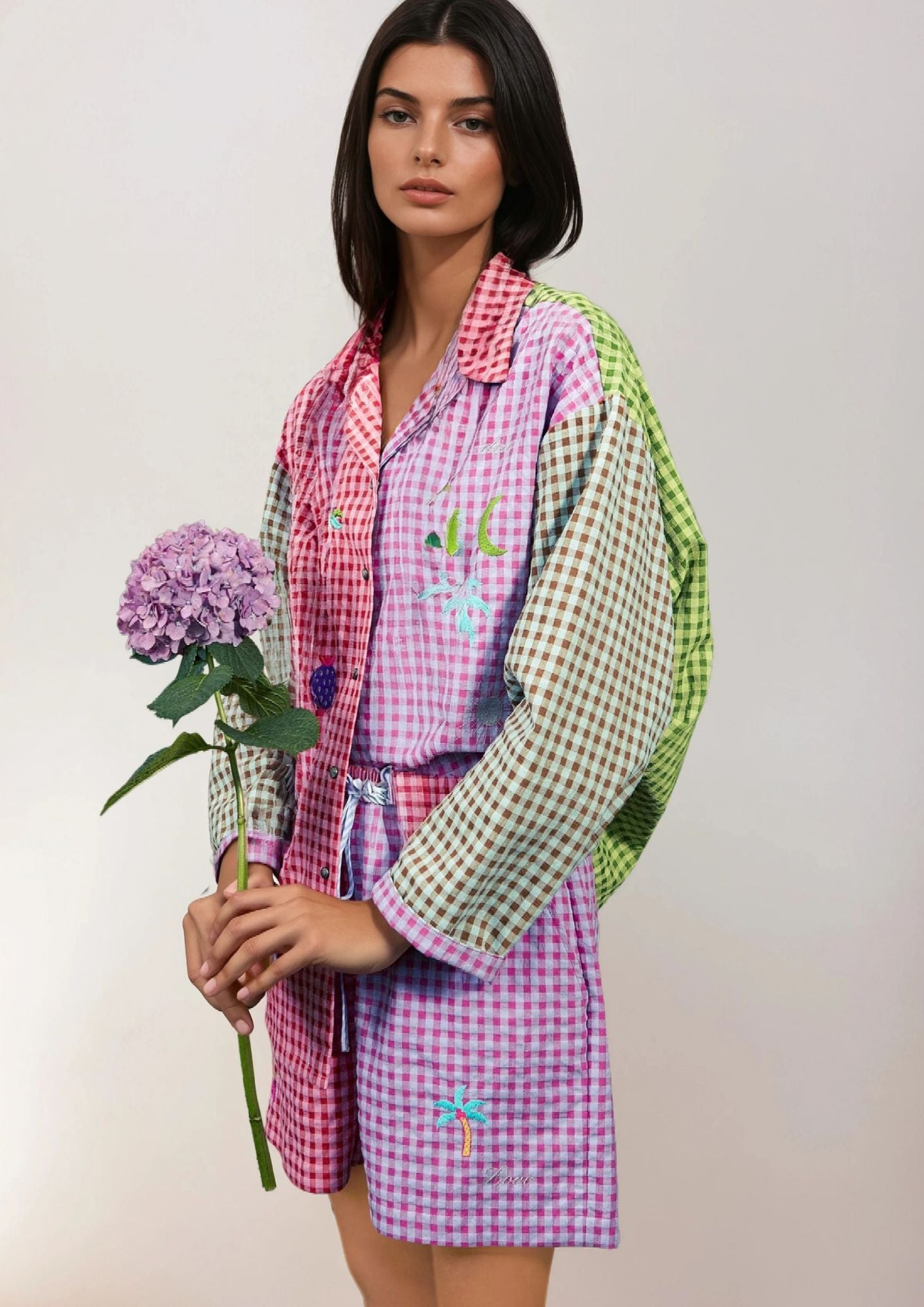 beautiful girl wearing a Susanna Blu Vichy shirt and shorts holding a flower