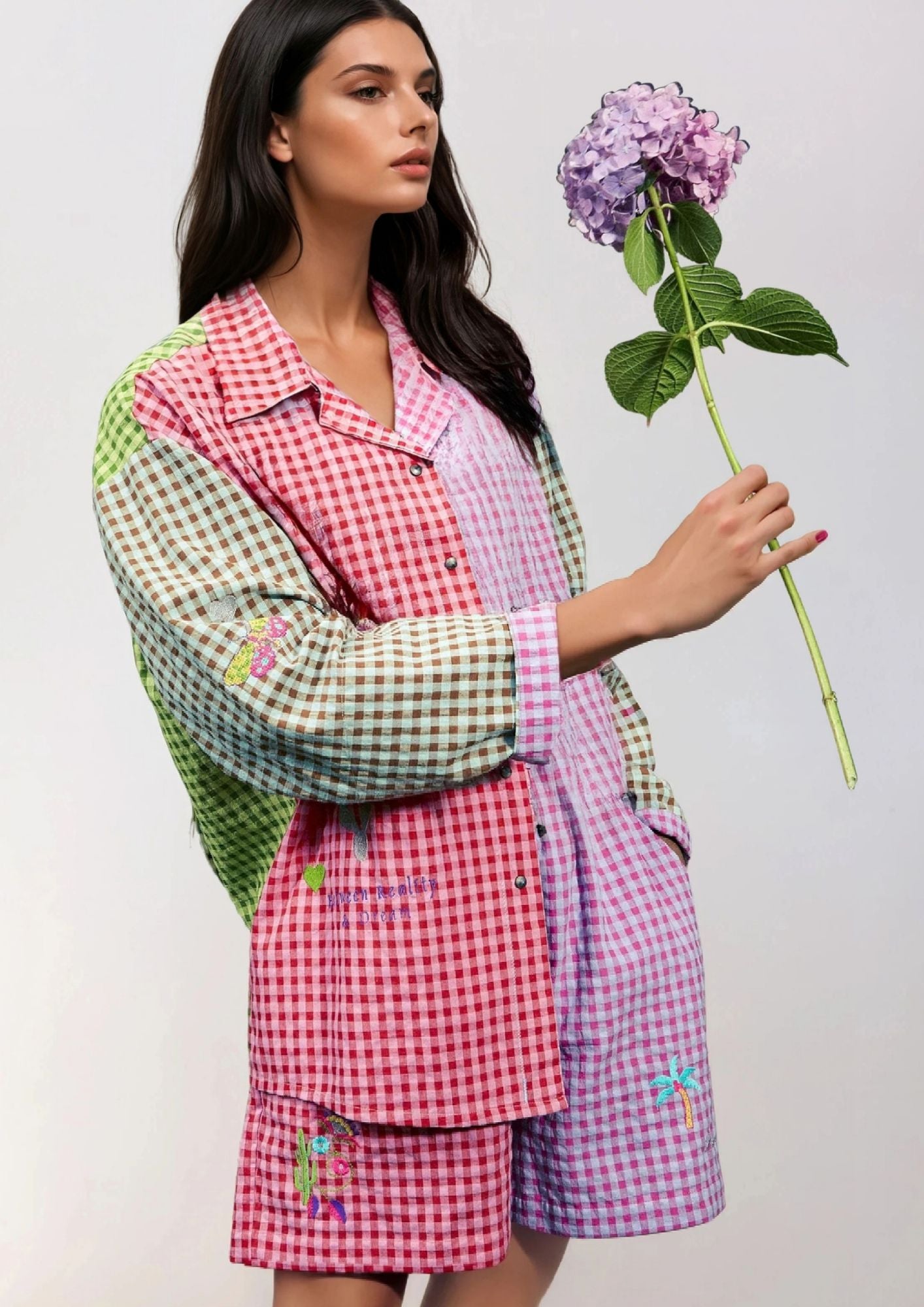 Girl holding a flower in a vichy heck shirt and shorts kitty van coesant