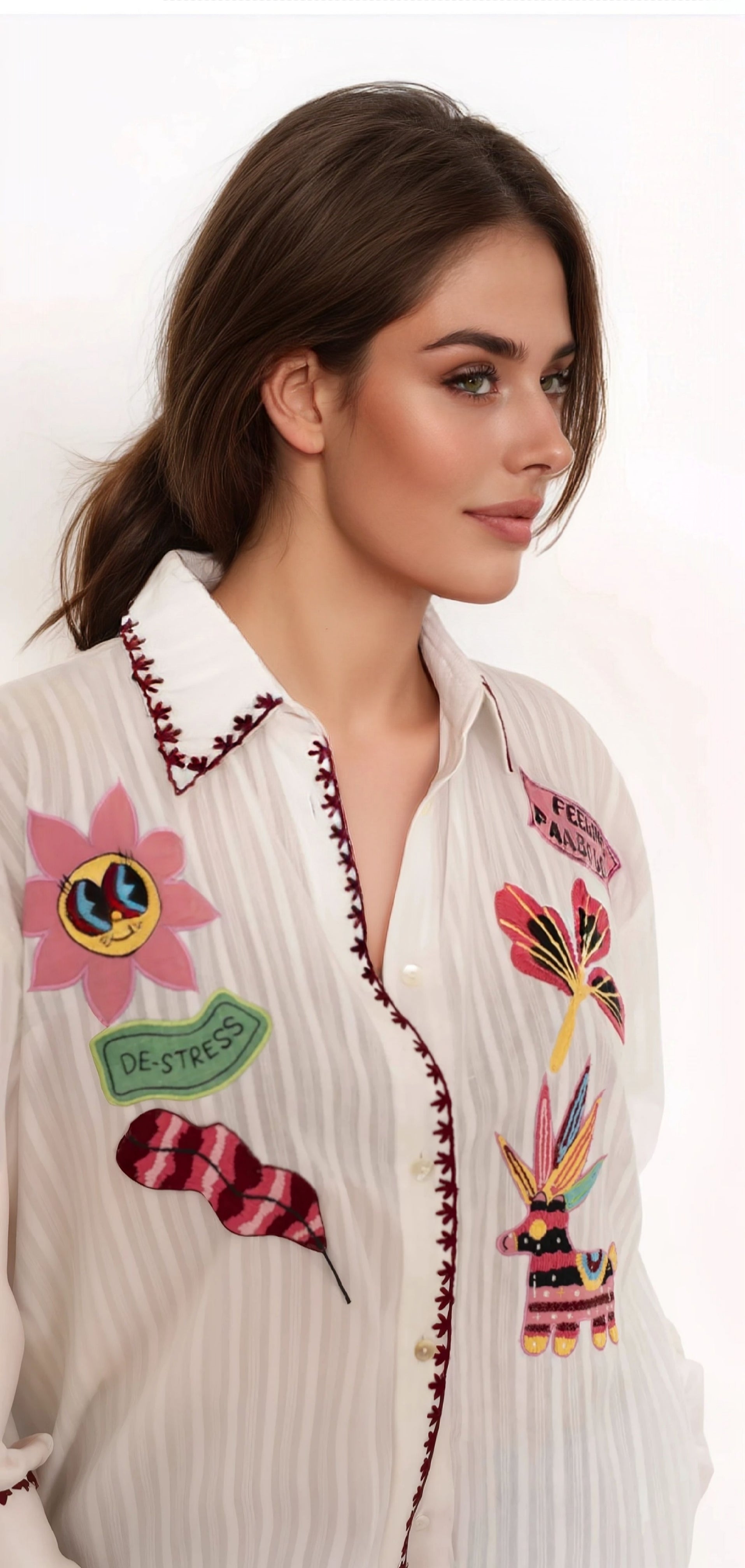 Brown hair girl with details of a white cotton shirt with colorful embroideries