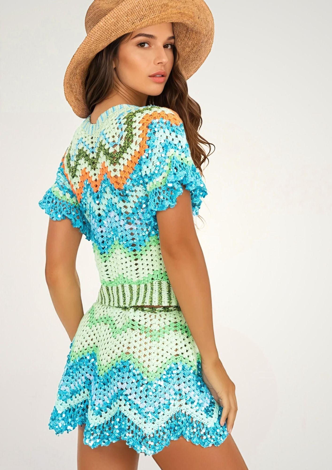A girl in a handcrocheted top and beach skirt with zigzag pattern, sideview