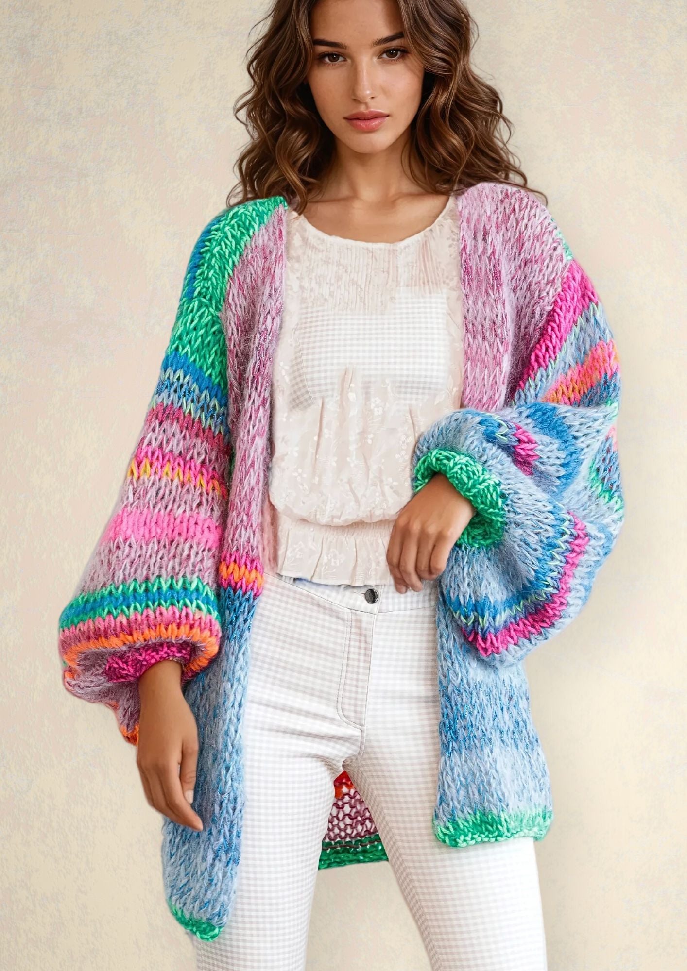 Woman with brown hair in a handknitted colorful cardigan in blue pink green