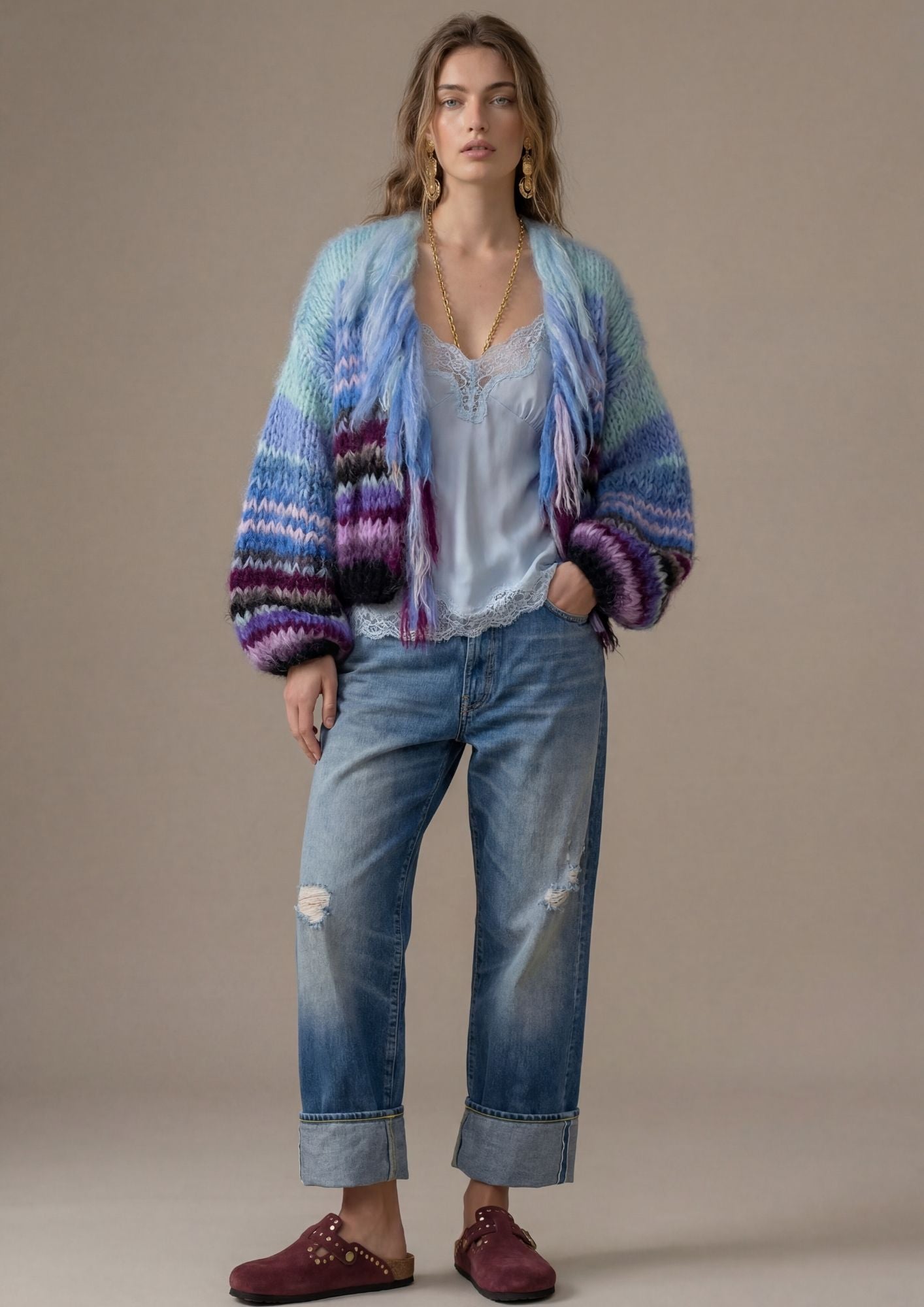 Woman wearing a colorful cardigan, light shirt, and jeans on a beige background