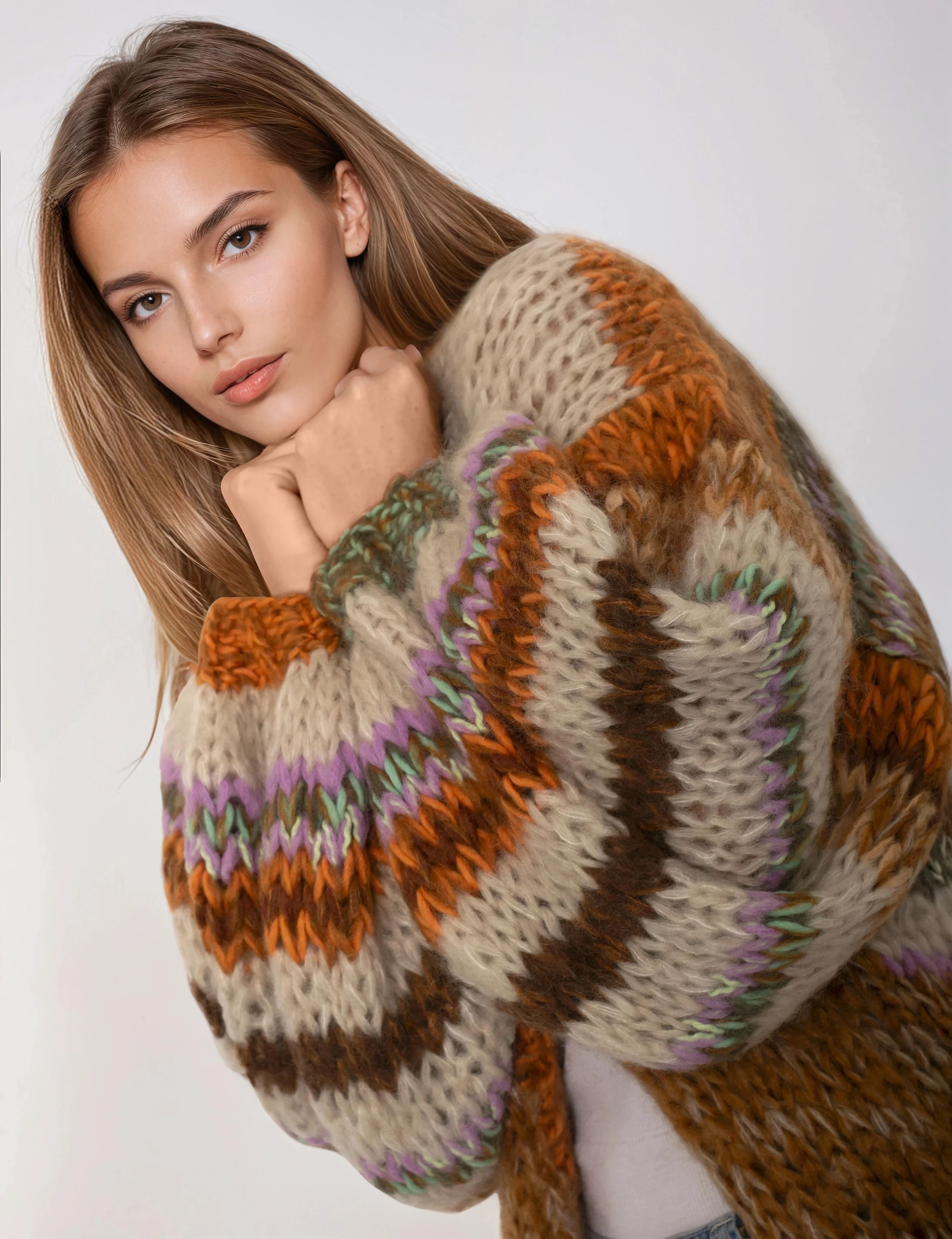 Woman wearing a patterned sweater against a white background