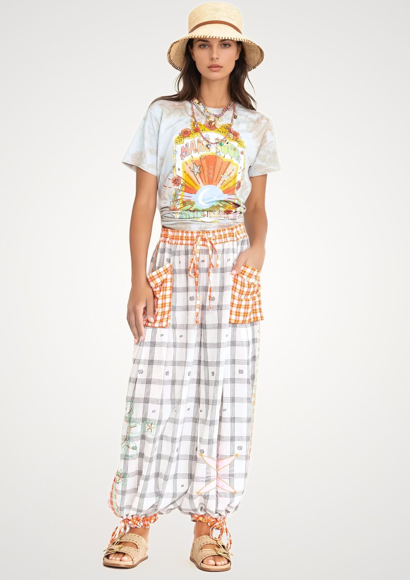 Girl in check fabric cargo pants and tiedye printed t shirt and hat