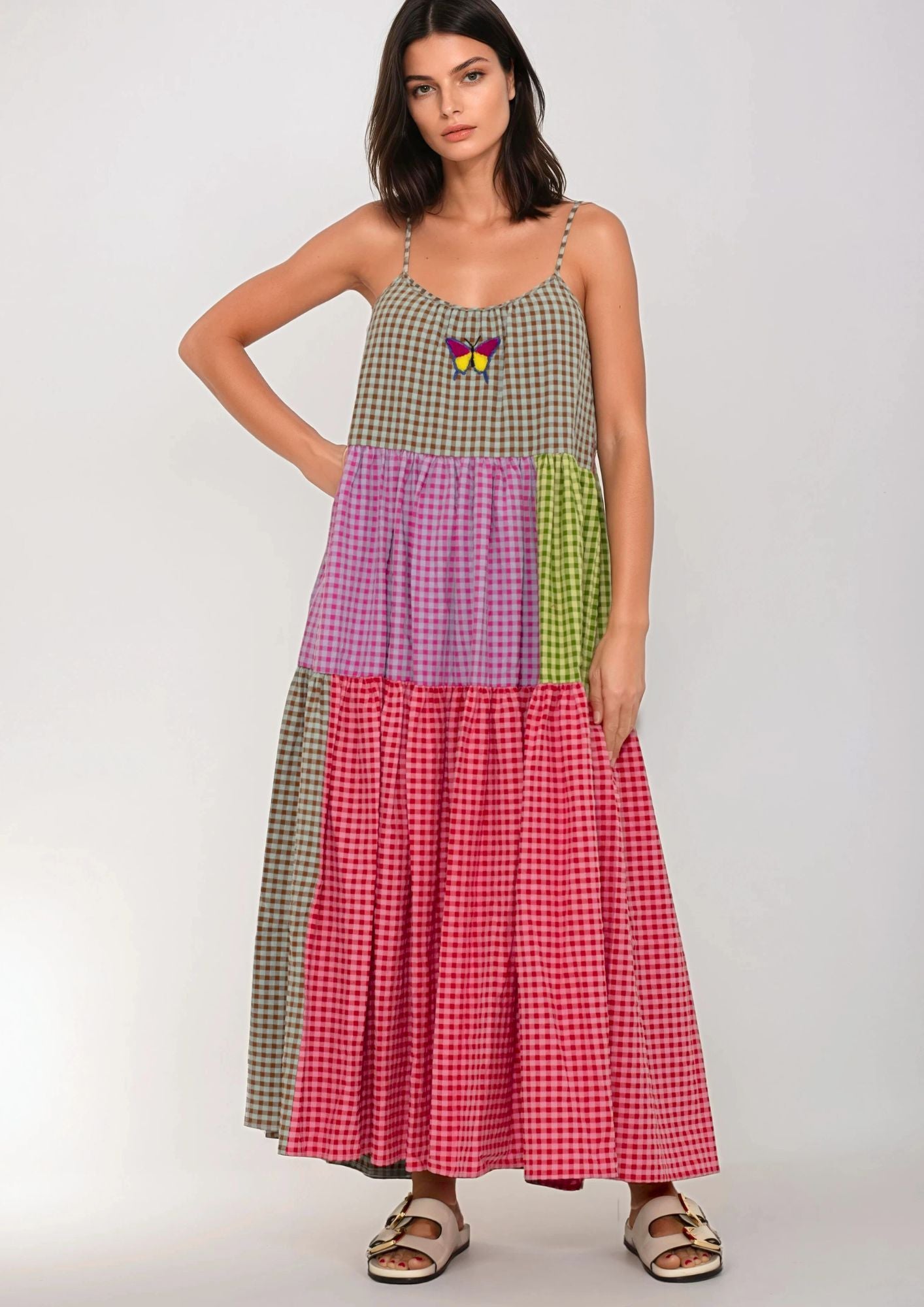 Woman wearing a colorful Susanna Blu patchwork dress on a white background