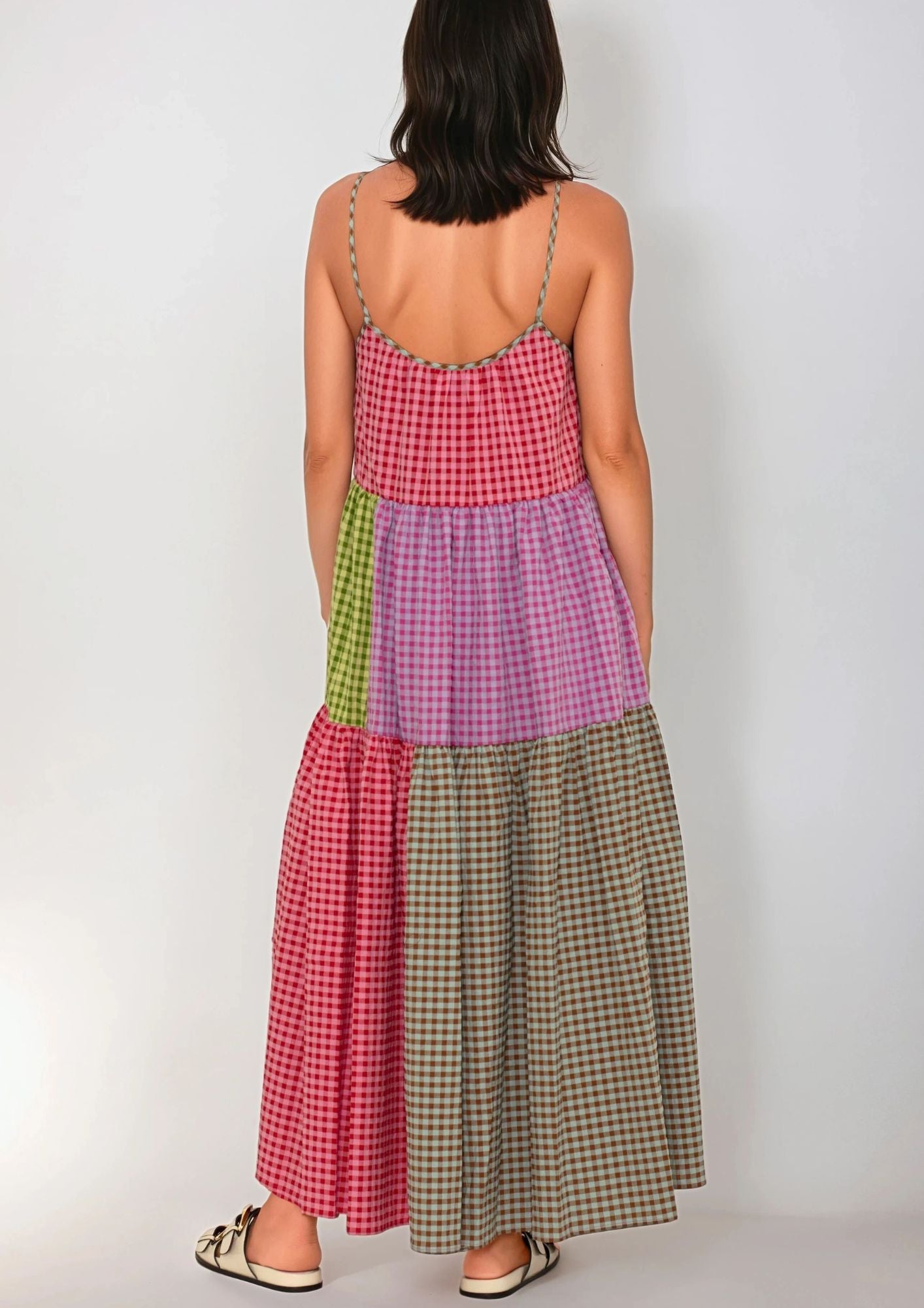 Woman wearing a patchwork Susanna Blu checkered dress on a white background