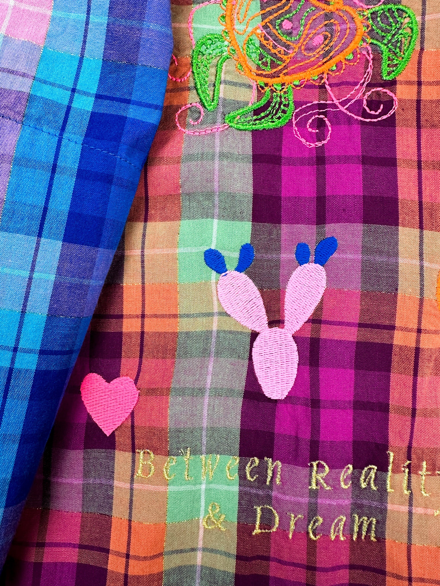 detail of Susanna Blu gingham shirt  with tropical embroideries