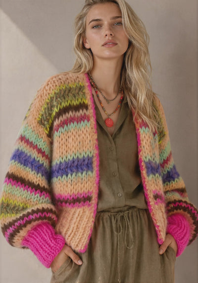 model wearing a handknitted light orange and pink cardigan